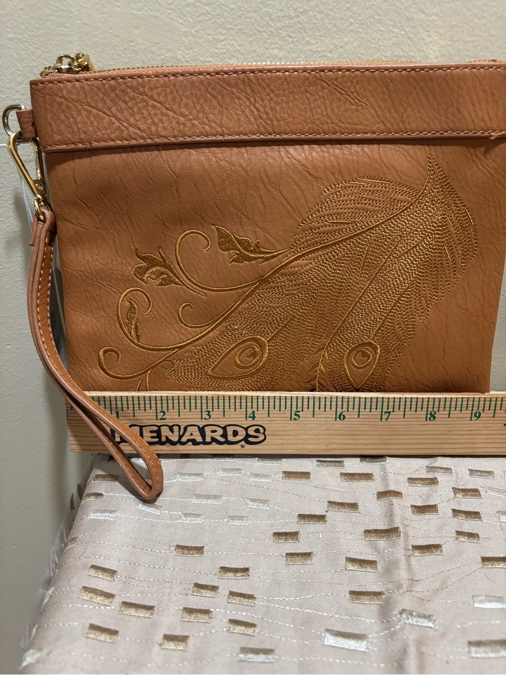 Charming Charlie Tan Wristlet Clutch with Embossed Feather Motif